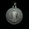 Medalla de plata con la imagen de San Benito y la cruz de San Benito y de acabados matizados y avejentados.